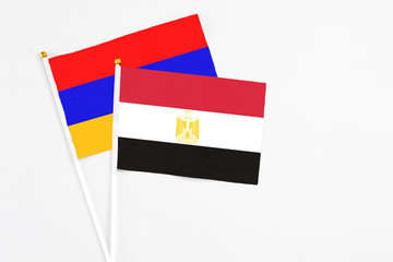 Egypt and Armenia stick flags on white background. High quality fabric, miniature national flag. Peaceful global concept.White floor for copy space.