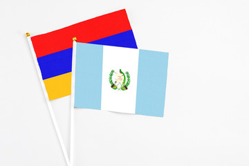 Guatemala and Armenia stick flags on white background. High quality fabric, miniature national flag. Peaceful global concept.White floor for copy space.