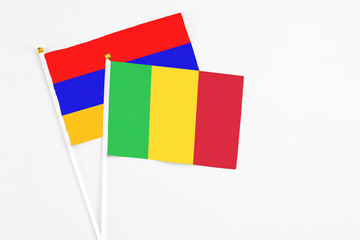 Mali and Armenia stick flags on white background. High quality fabric, miniature national flag. Peaceful global concept.White floor for copy space.