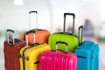 Many multi-colored big suitcases on the background of the airport