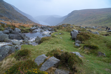 Glendalough Upper lake from miners way, Glenealo valley, Wicklow way, County Wicklow, Ireland. Autumn hike during foggy weather and mist.