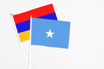 Somalia and Armenia stick flags on white background. High quality fabric, miniature national flag. Peaceful global concept.White floor for copy space.