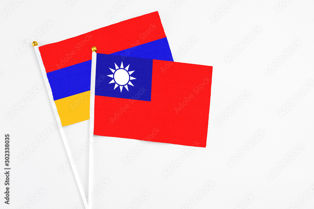 Wall mural Taiwan and Armenia stick flags on white background. High quality fabric, miniature national flag. Peaceful global concept.White floor for copy space.