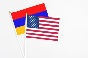 United States and Armenia stick flags on white background. High quality fabric, miniature national flag. Peaceful global concept.White floor for copy space.