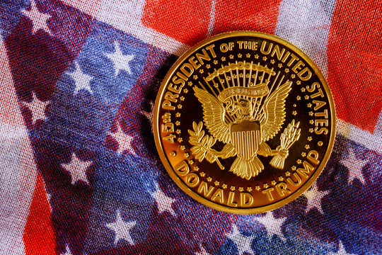 Presiden Donald Trump coin against US flag background in the election 2020