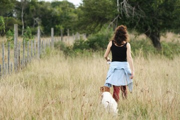 Girl walks on the field with her shaggy friends