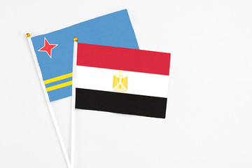 Egypt and Aruba stick flags on white background. High quality fabric, miniature national flag. Peaceful global concept.White floor for copy space.