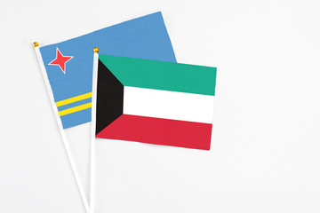 Kuwait and Aruba stick flags on white background. High quality fabric, miniature national flag. Peaceful global concept.White floor for copy space.