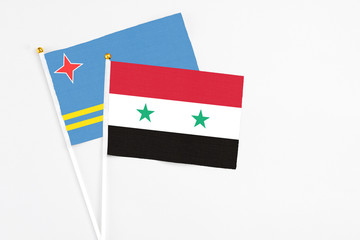 Syria and Aruba stick flags on white background. High quality fabric, miniature national flag....