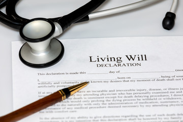 Living Will declaration form with stethoscope and ballpoint pen. Concept of planning end of life medical and healthcare wishes