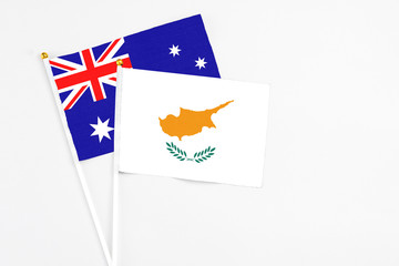 Cyprus and Australia stick flags on white background. High quality fabric, miniature national flag. Peaceful global concept.White floor for copy space.