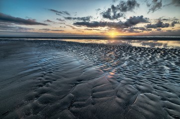 The sunset reflected in a mudflat