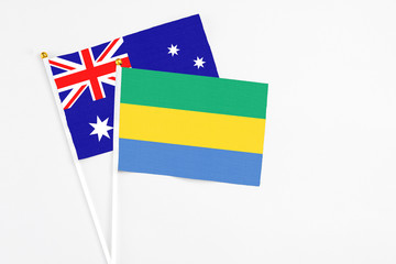 Gabon and Australia stick flags on white background. High quality fabric, miniature national flag....
