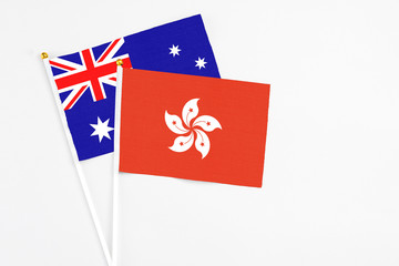 Hong Kong and Australia stick flags on white background. High quality fabric, miniature national flag. Peaceful global concept.White floor for copy space.