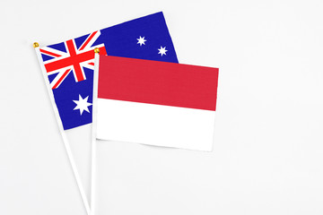 Indonesia and Australia stick flags on white background. High quality fabric, miniature national flag. Peaceful global concept.White floor for copy space.