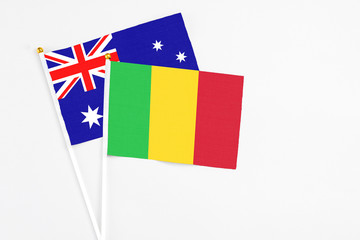 Mali and Australia stick flags on white background. High quality fabric, miniature national flag. Peaceful global concept.White floor for copy space.