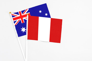 Peru and Australia stick flags on white background. High quality fabric, miniature national flag. Peaceful global concept.White floor for copy space.