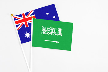 Saudi Arabia and Australia stick flags on white background. High quality fabric, miniature national flag. Peaceful global concept.White floor for copy space.