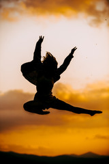 Fototapeta na wymiar Teenager silhouette girl jumping in hip hop style