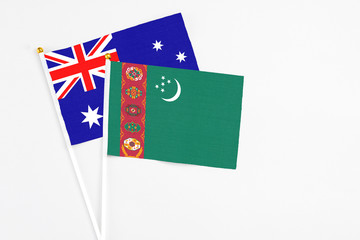 Turkmenistan and Australia stick flags on white background. High quality fabric, miniature national flag. Peaceful global concept.White floor for copy space.