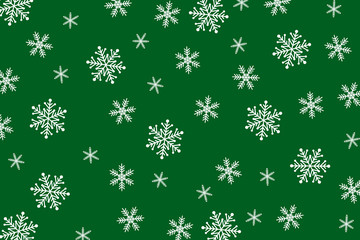 Christmas background of big and small snowflakes, white on green