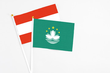 Macao and Austria stick flags on white background. High quality fabric, miniature national flag. Peaceful global concept.White floor for copy space.
