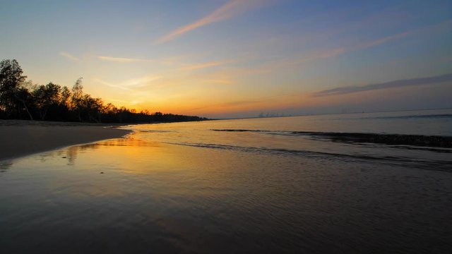 Peaceful Landscape of Calm Sea Waves on Sandy Beach after Sunset