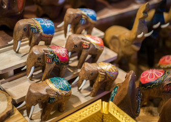 Close-up view of the carved wooden elephants selling in the souvenirs stall at Ratchada Rot Fai...
