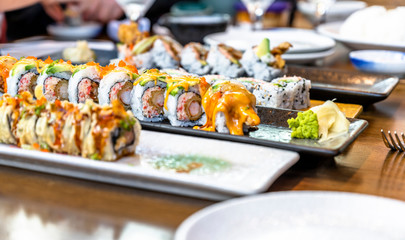 Appetizing Sushi on plates on a dining table