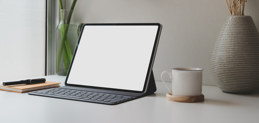 Cropped shot of blank screen digital tablet and office supplies with coffee cup
