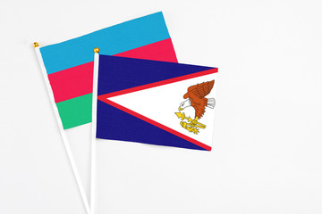 American Samoa and Azerbaijan stick flags on white background. High quality fabric, miniature...