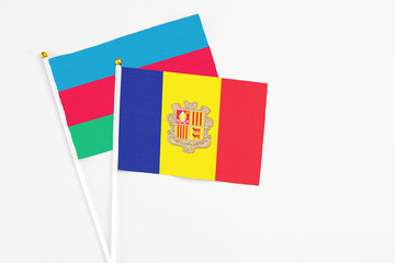 Andorra and Azerbaijan stick flags on white background. High quality fabric, miniature national flag. Peaceful global concept.White floor for copy space.