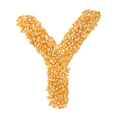 Letter Y of the English alphabet from from yellow dry corn  on a white isolated background. Food pattern made from corn. bright alphabet for shops. cereal for corn porridge