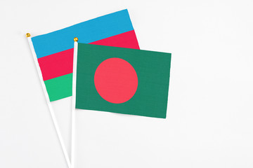 Bangladesh and Azerbaijan stick flags on white background. High quality fabric, miniature national flag. Peaceful global concept.White floor for copy space.