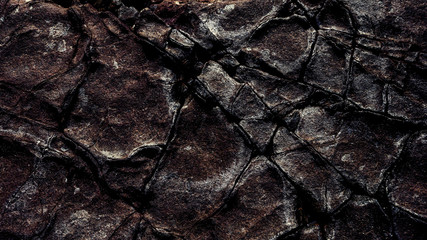 stone texture with a rough surface with cracks and faults in contrast brown color