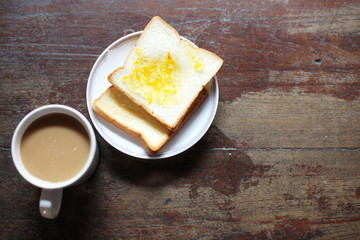 Coffee, toast on a wooden table