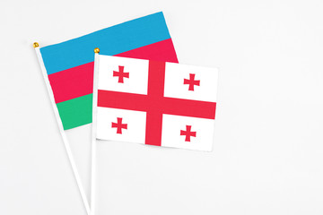 Georgia and Azerbaijan stick flags on white background. High quality fabric, miniature national flag. Peaceful global concept.White floor for copy space.