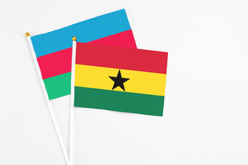 Ghana and Azerbaijan stick flags on white background. High quality fabric, miniature national flag. Peaceful global concept.White floor for copy space.