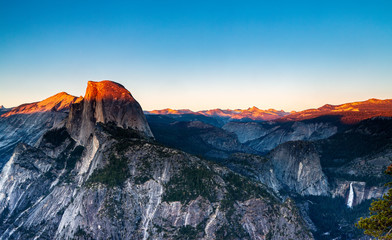 Panoramic View of Sunlight Lighting the Mountain Tops of Half Dome and Yosemite Valley at Sunset in Yosemite National Park