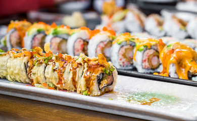 Sliced sushi on plates on a dining table