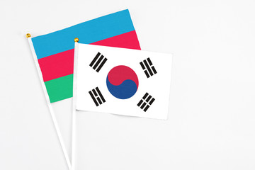 South Korea and Azerbaijan stick flags on white background. High quality fabric, miniature national flag. Peaceful global concept.White floor for copy space.
