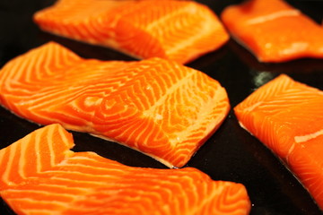 Fresh orange salmon fillets on the market
