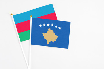Kosovo and Azerbaijan stick flags on white background. High quality fabric, miniature national flag. Peaceful global concept.White floor for copy space.