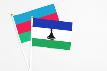 Lesotho and Azerbaijan stick flags on white background. High quality fabric, miniature national...