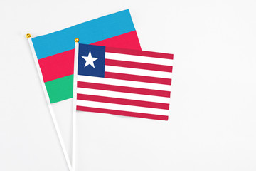 Liberia and Azerbaijan stick flags on white background. High quality fabric, miniature national...