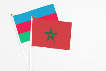 Morocco and Azerbaijan stick flags on white background. High quality fabric, miniature national flag. Peaceful global concept.White floor for copy space.