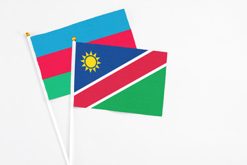 Namibia and Azerbaijan stick flags on white background. High quality fabric, miniature national flag. Peaceful global concept.White floor for copy space.