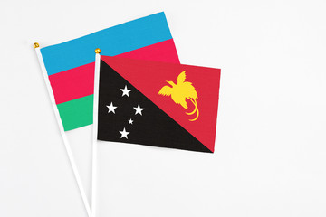 Papua New Guinea and Azerbaijan stick flags on white background. High quality fabric, miniature national flag. Peaceful global concept.White floor for copy space.