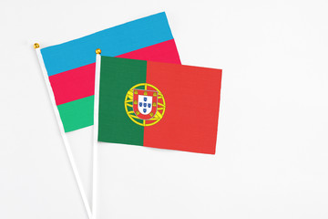 Portugal and Azerbaijan stick flags on white background. High quality fabric, miniature national flag. Peaceful global concept.White floor for copy space.