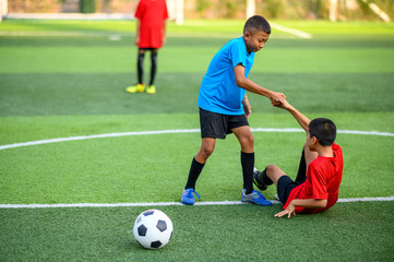 Boys playing football on the football practice field